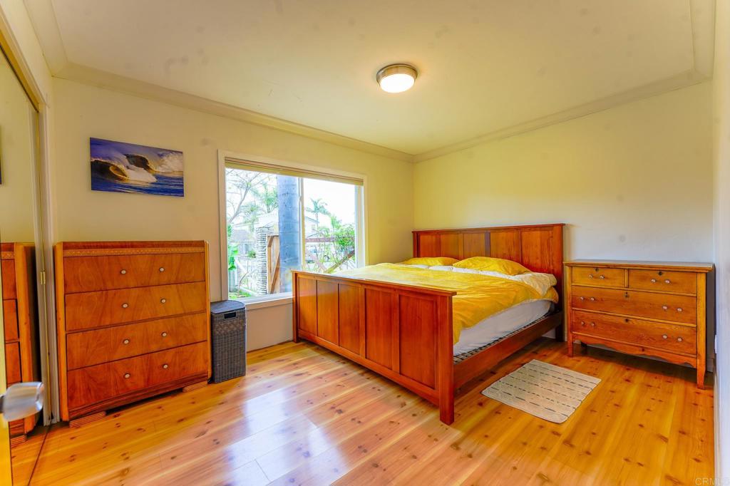 1043 Aloha Drive Encinitas, CA 92024 - Photo 19 of 27 a bedroom with a bed and window