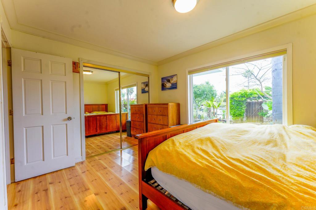 1043 Aloha Drive Encinitas, CA 92024 - Photo 20 of 27 a bed sitting in a spacious bedroom next to a window