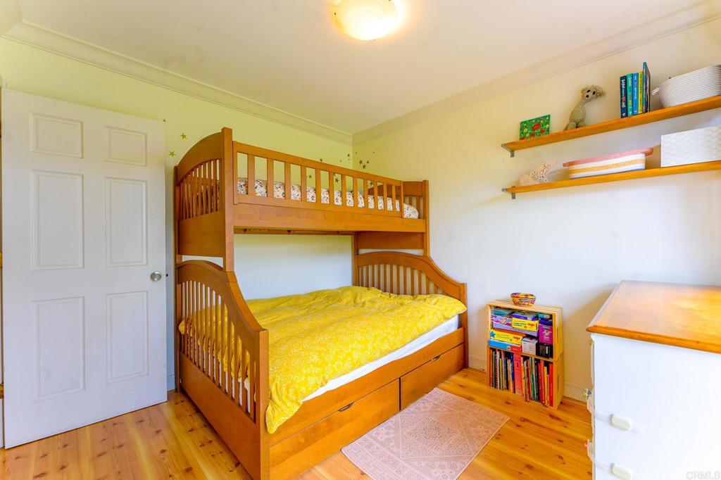 1043 Aloha Drive Encinitas, CA 92024 - Photo 21 of 27 a bed room with a bed and a baby crib