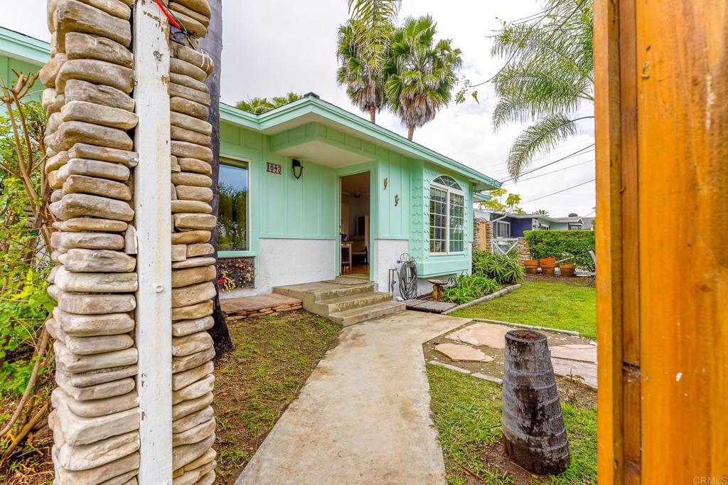 1043 Aloha Drive Encinitas, CA 92024 - Photo 5 of 27 a front view of a house with a garden and plants