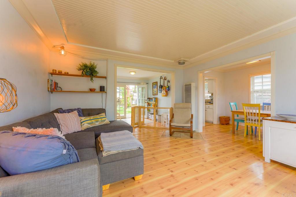 1043 Aloha Drive Encinitas, CA 92024 - Photo 10 of 27 a living room with furniture and a dining table with kitchen view