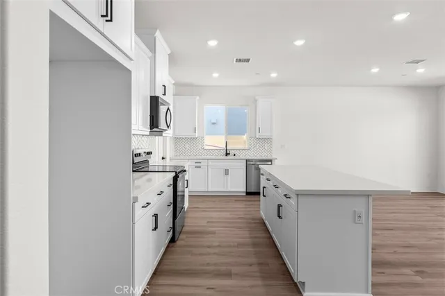a kitchen with white cabinets