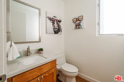 a bedroom with a bed and a flat tv screen next to a window