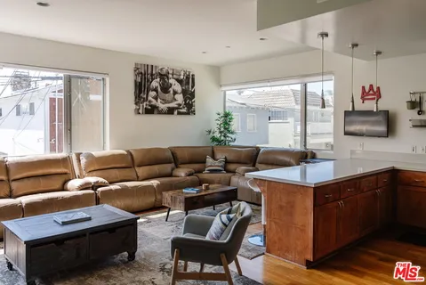 a kitchen with stainless steel appliances kitchen island granite countertop a refrigerator and a stove top oven