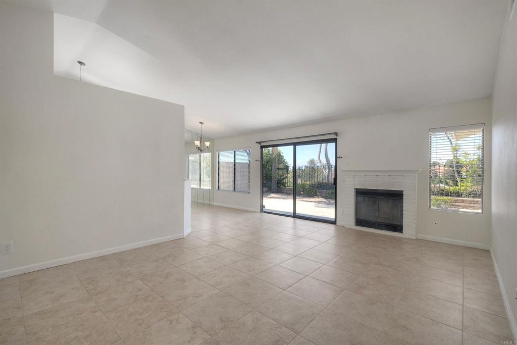 1394 Longfellow Road Vista, CA 92081 - Photo 10 of 50 a view of an empty room with a fireplace and a window