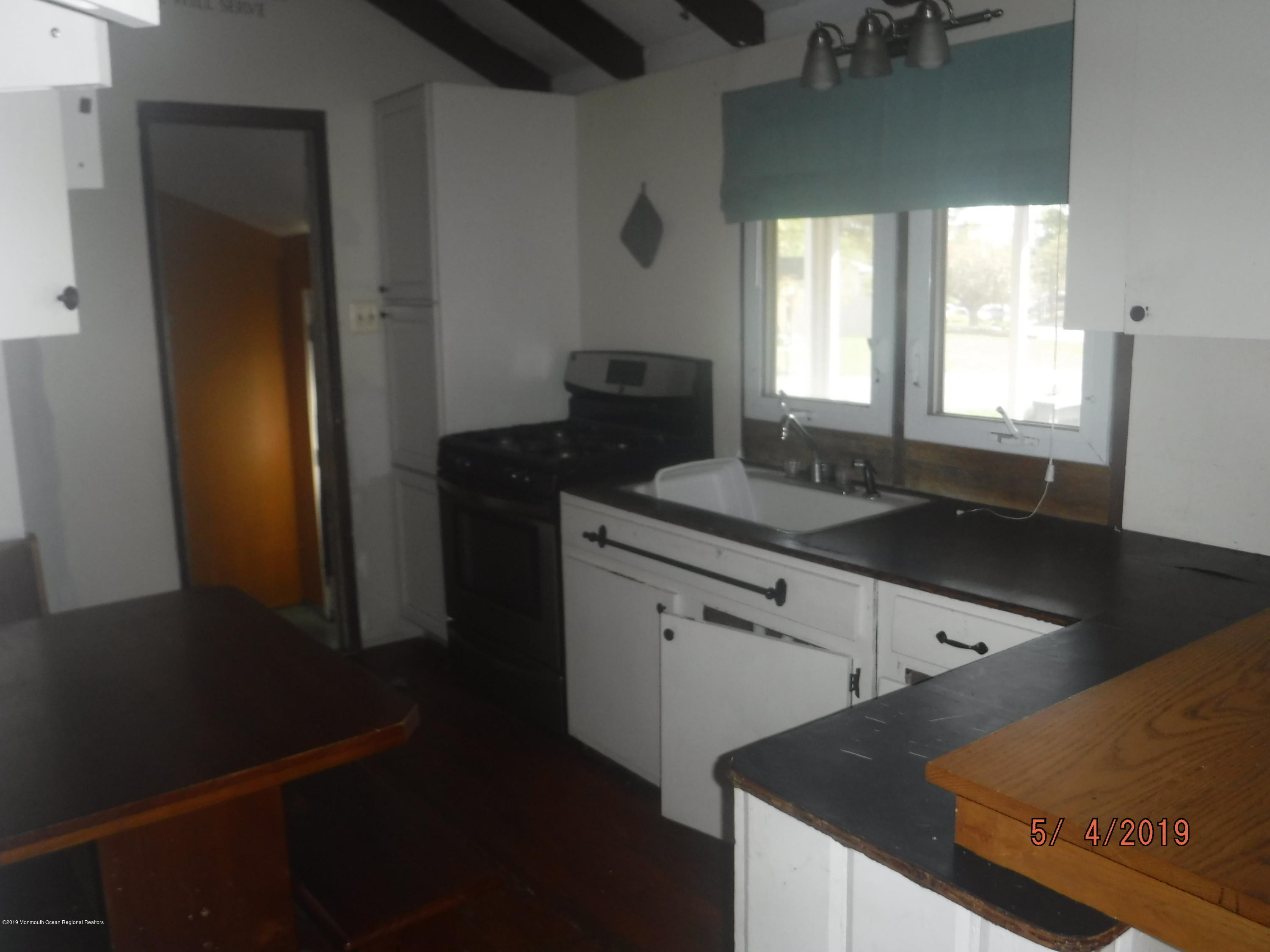 2120 Whitcomb Road Forked River, NJ 08731 - Photo 9 of 29 a kitchen with a sink and a refrigerator