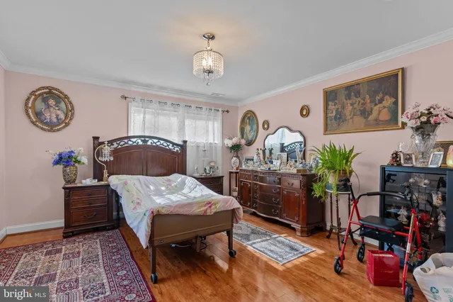 a bedroom with bed and wooden floor