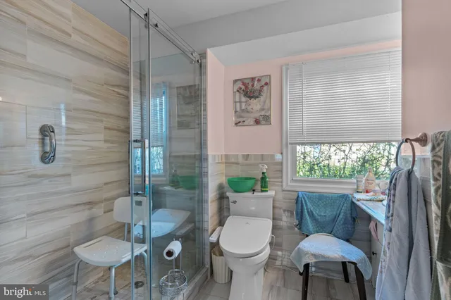 a bathroom with a sink mirror and window