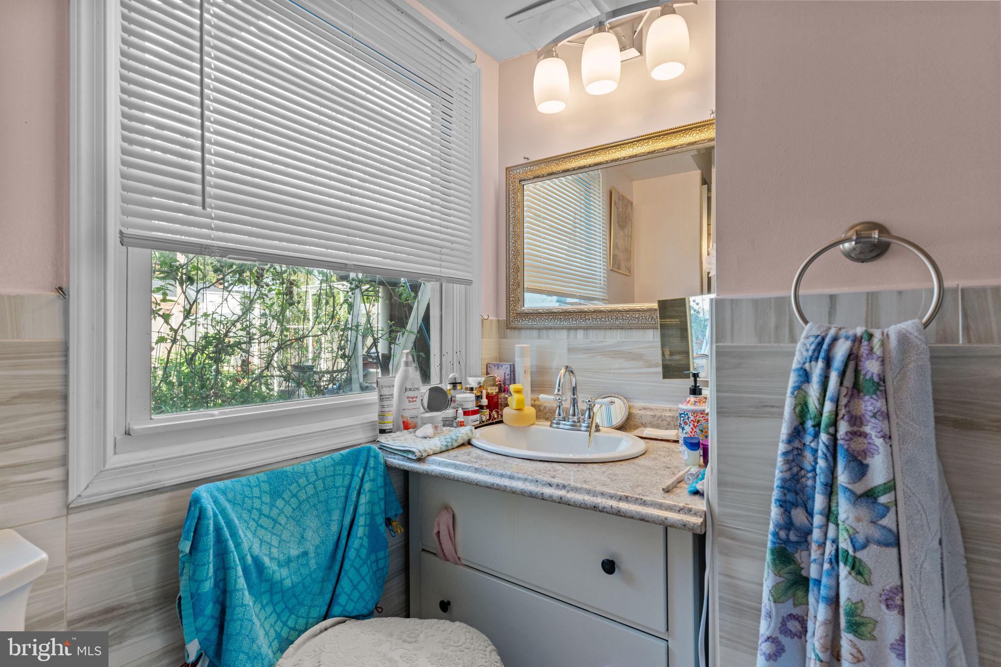 813 Piermont Street Philadelphia, PA 19116 - Photo 15 of 37 a bathroom with a sink mirror and window