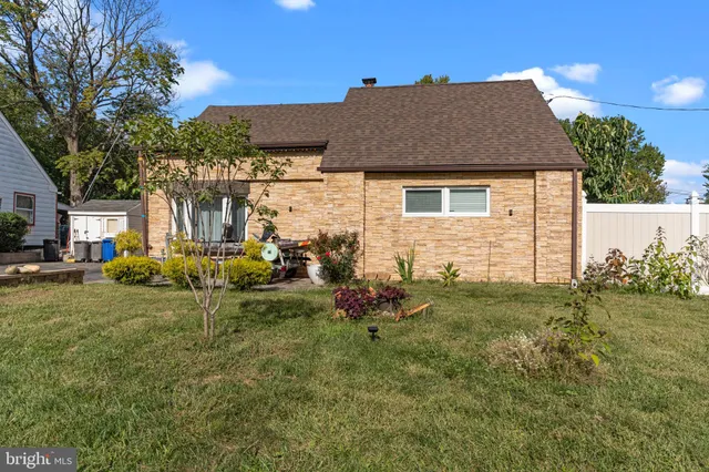 a view of backyard of house with green space