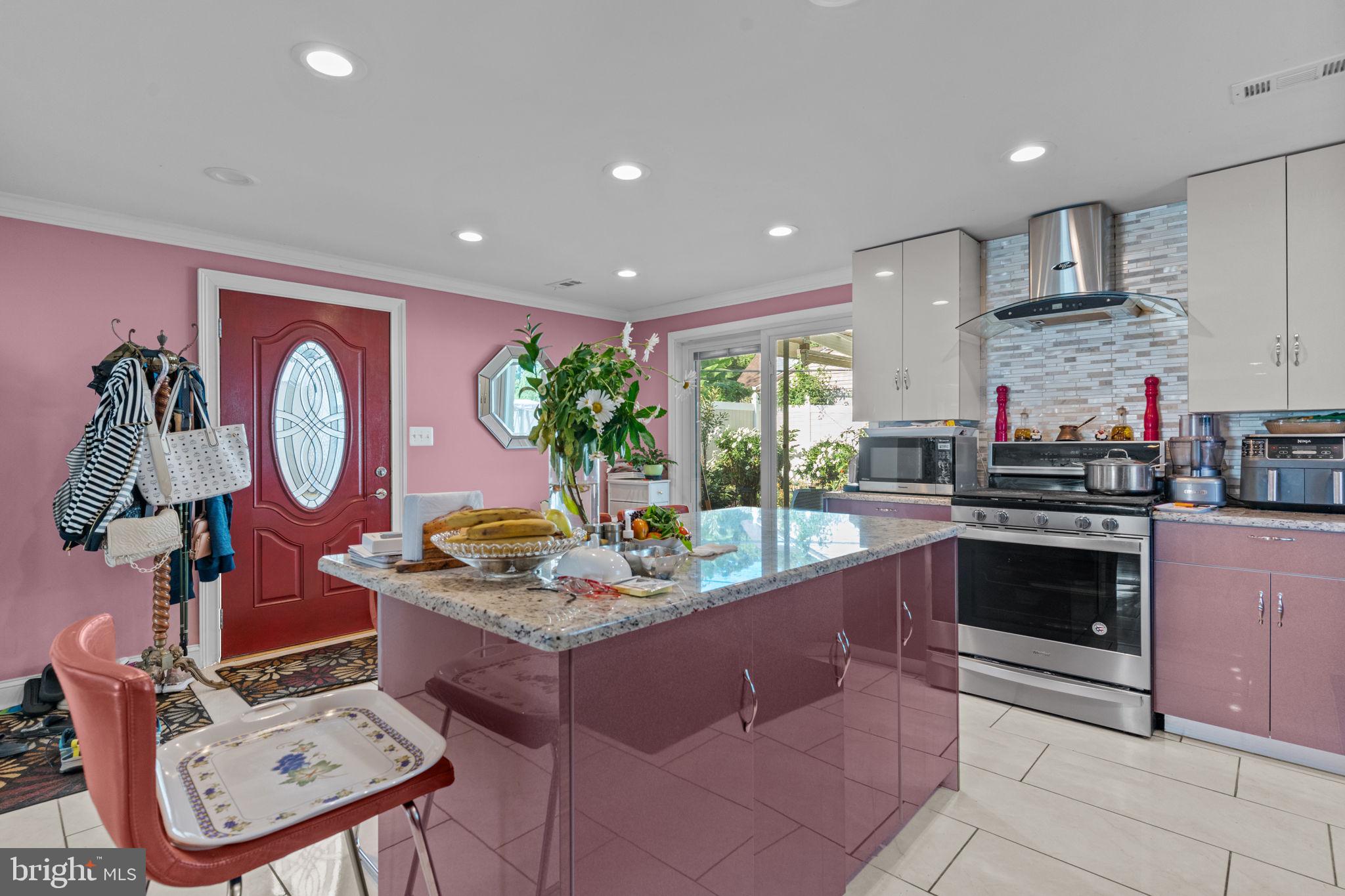 813 Piermont Street Philadelphia, PA 19116 - Photo 22 of 37 a kitchen with stainless steel appliances granite countertop a stove a sink and a microwave