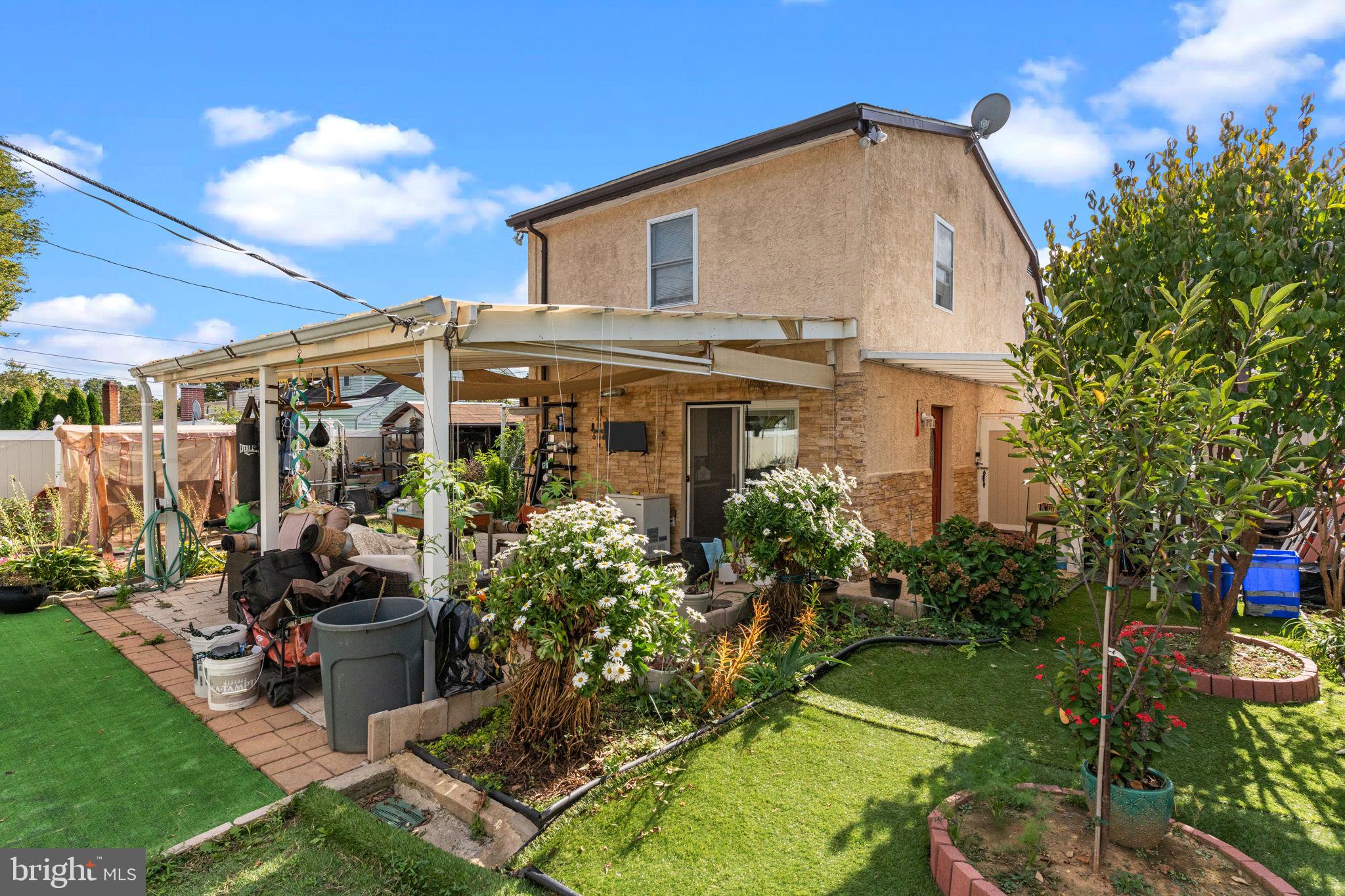 813 Piermont Street Philadelphia, PA 19116 - Photo 35 of 37 a view of a house with backyard sitting area and garden