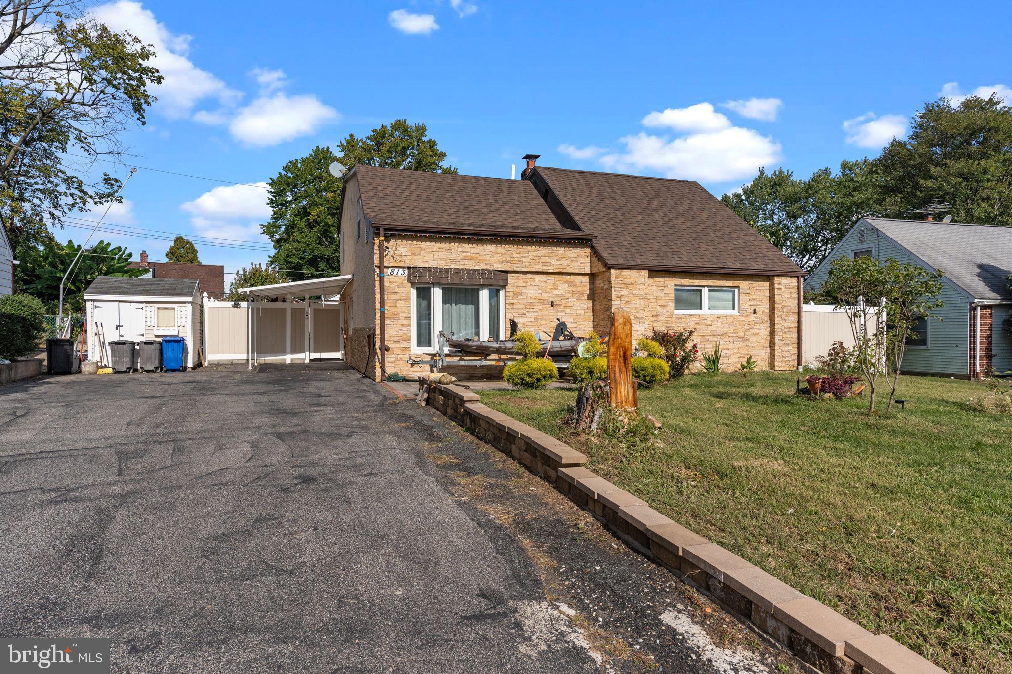 813 Piermont Street Philadelphia, PA 19116 - Photo 36 of 37 a view of a white house next to a yard with big trees