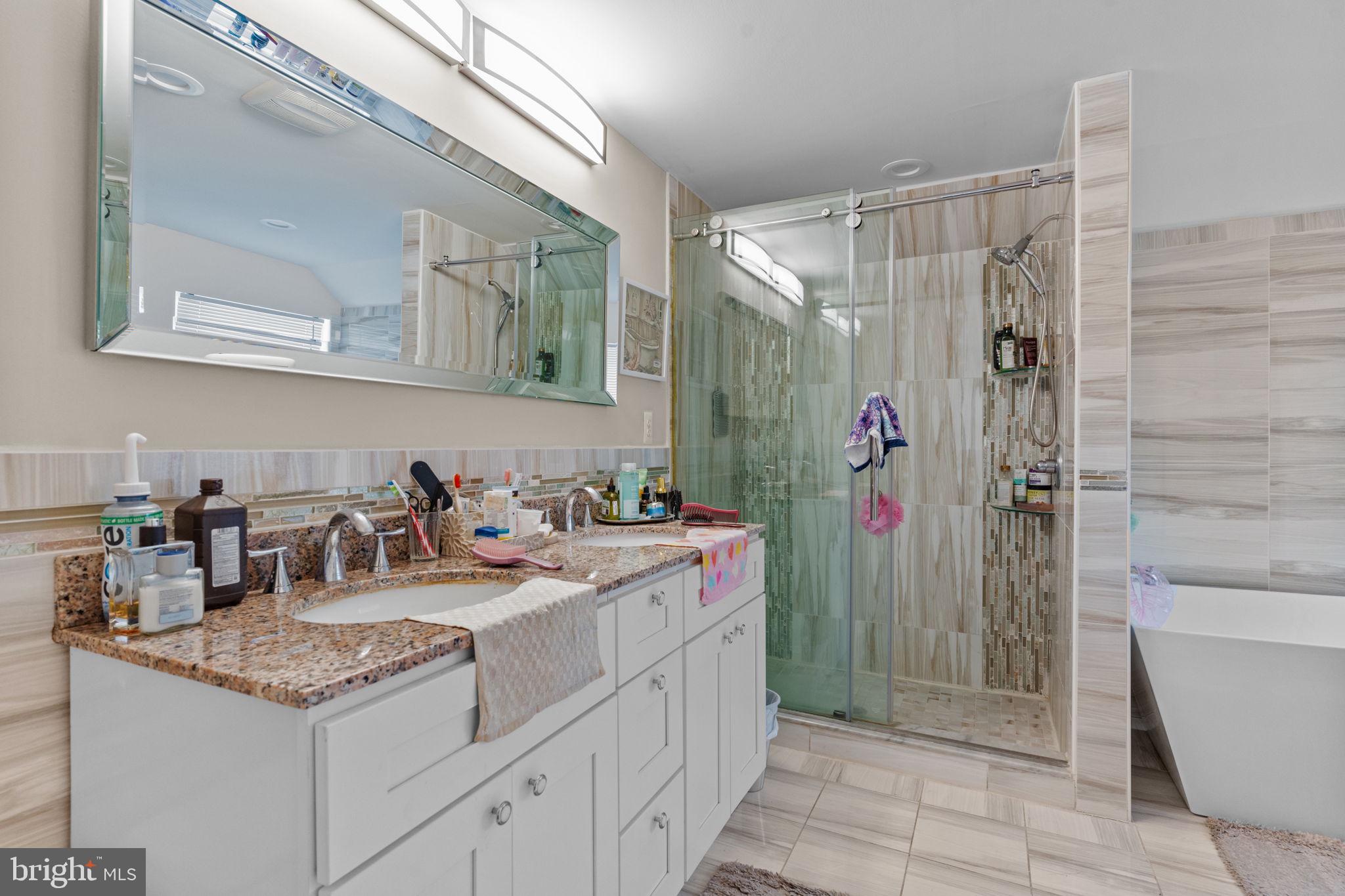 813 Piermont Street Philadelphia, PA 19116 - Photo 9 of 37 a bathroom with a granite countertop sink and a mirror
