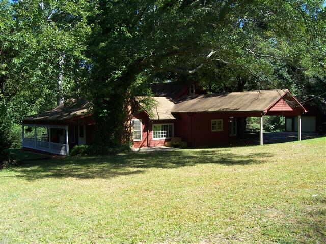 a house that has a big yard with large trees