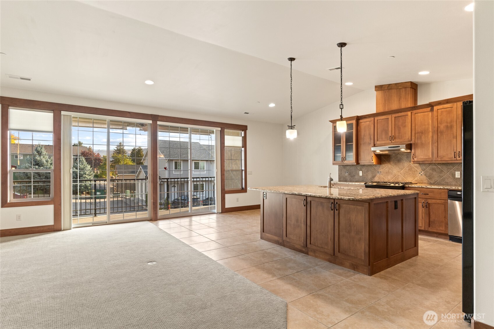 1051 North Baker Avenue, Unit B203 East Wenatchee, WA 98802 - Photo 12 of 33 a open kitchen with stainless steel appliances granite countertop a stove and a large refrigerator