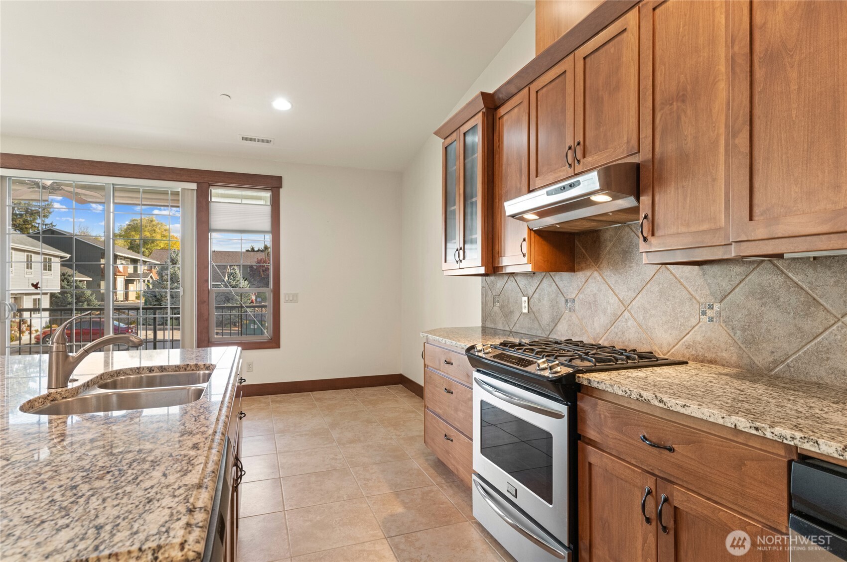 1051 North Baker Avenue, Unit B203 East Wenatchee, WA 98802 - Photo 16 of 33 a kitchen with granite countertop a stove and a sink