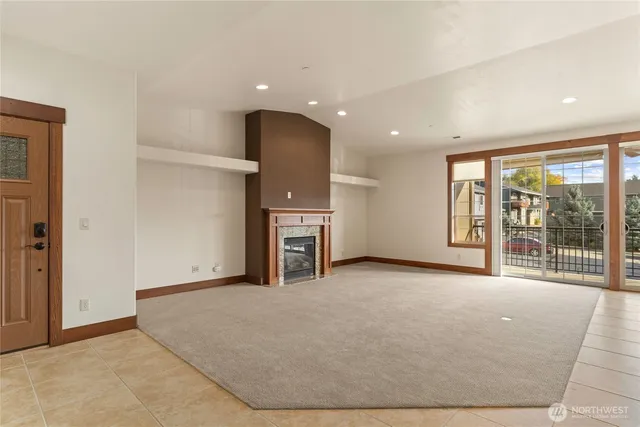a view of an empty room with a fireplace