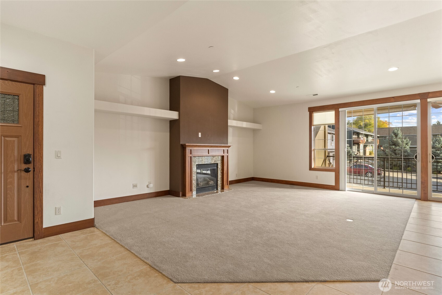 1051 North Baker Avenue, Unit B203 East Wenatchee, WA 98802 - Photo 8 of 33 an empty room with fireplace cabinet and windows