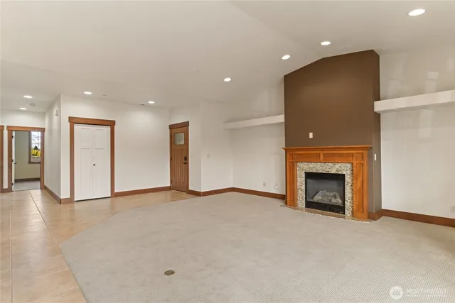 a kitchen with stainless steel appliances kitchen island granite countertop a stove a sink and a refrigerator