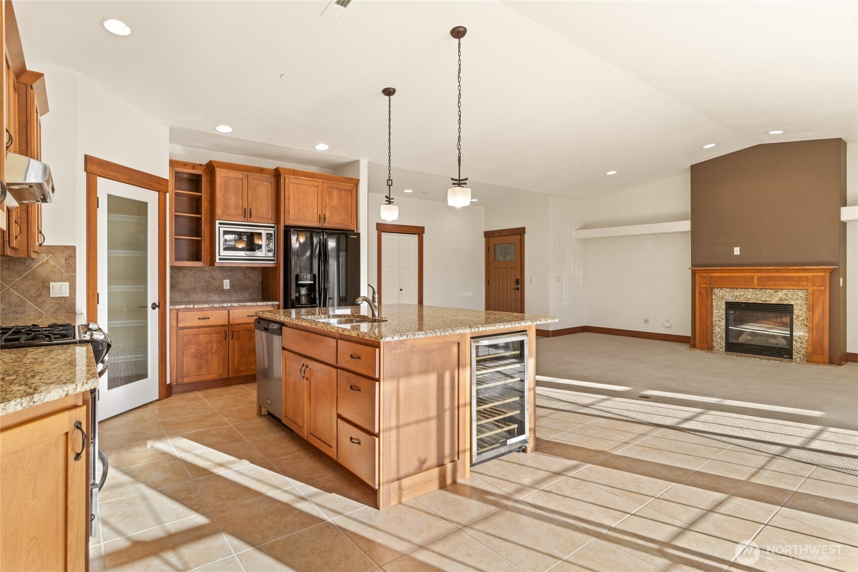 1051 North Baker Avenue, Unit B203 East Wenatchee, WA 98802 - Photo 10 of 33 a kitchen with stainless steel appliances kitchen island granite countertop a stove a sink and a refrigerator