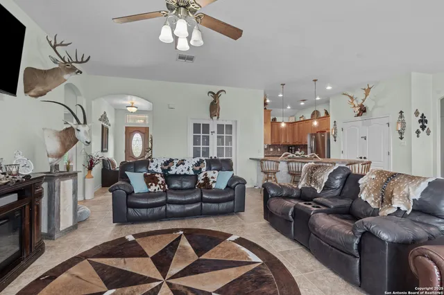 a living room with furniture and a chandelier