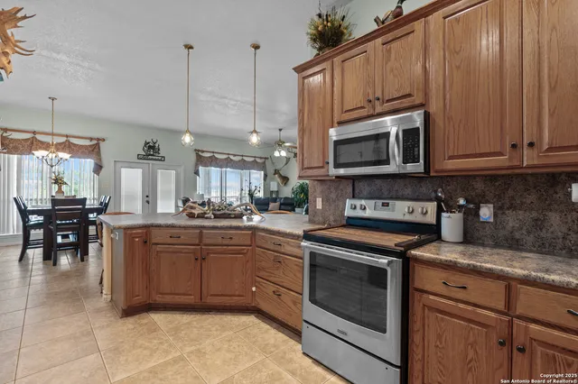 a kitchen with cabinets appliances and a counter top space