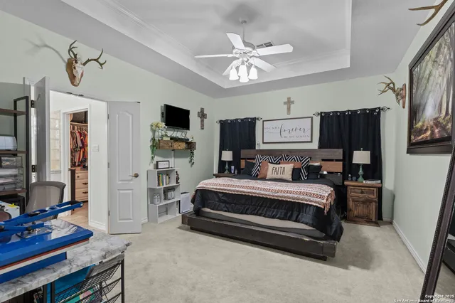 a bedroom with furniture and a flat screen tv