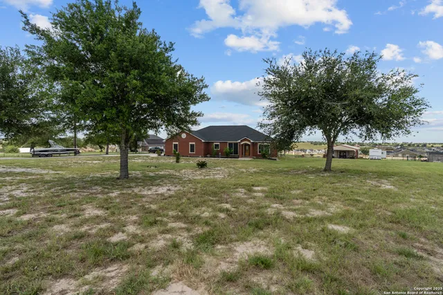 a view of a house with a yard