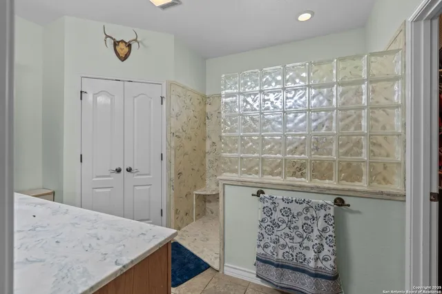 a bathroom with a granite countertop sink a shower and a bathtub