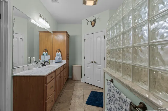 a bathroom with a double vanity sink and a mirror