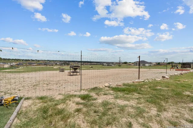 a view of a lake with houses in the background