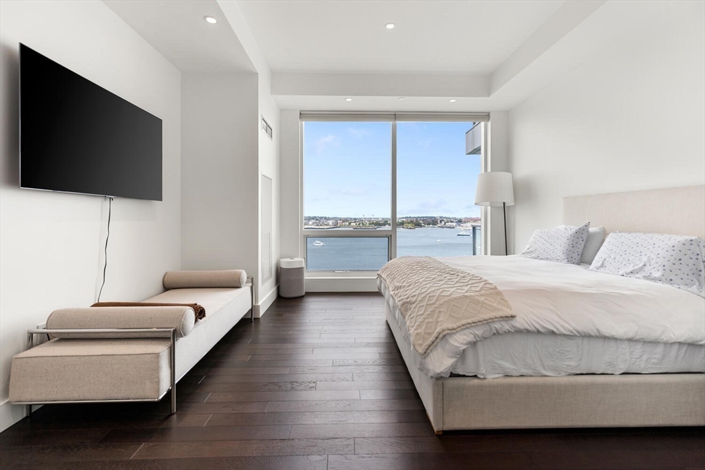 22 Liberty Drive, Unit 10D Boston, MA 02210 - Photo 13 of 26 a spacious bedroom with a bed and a flat screen tv
