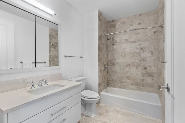 a bedroom with a bed and a view of kitchen