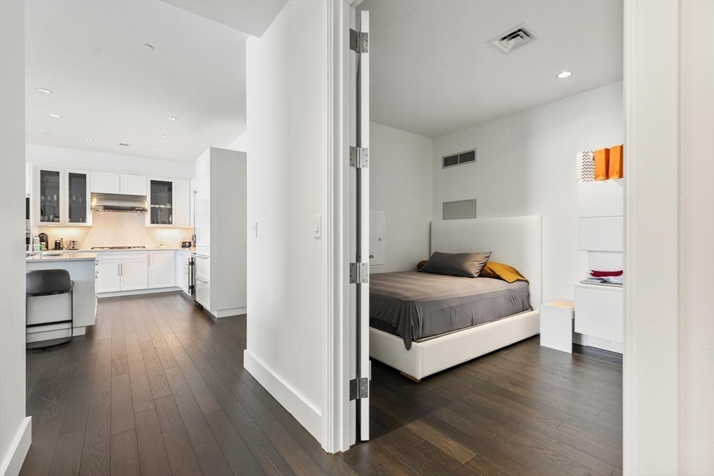 22 Liberty Drive, Unit 10D Boston, MA 02210 - Photo 20 of 26 a bedroom with a bed and a view of kitchen