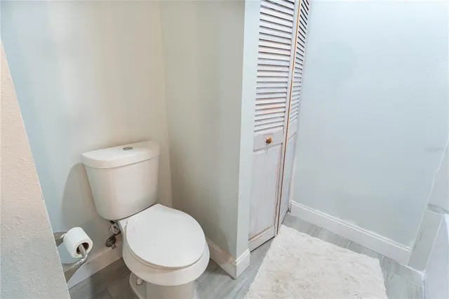 a white toilet sitting next to a shower