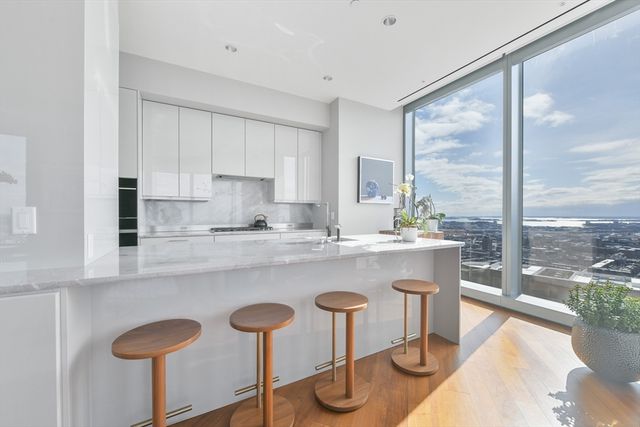 a kitchen with a table chairs sink and cabinets