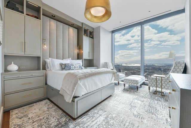 a bedroom with a bed and large window