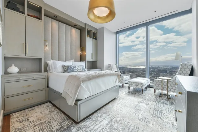 a bedroom with a bed and large window