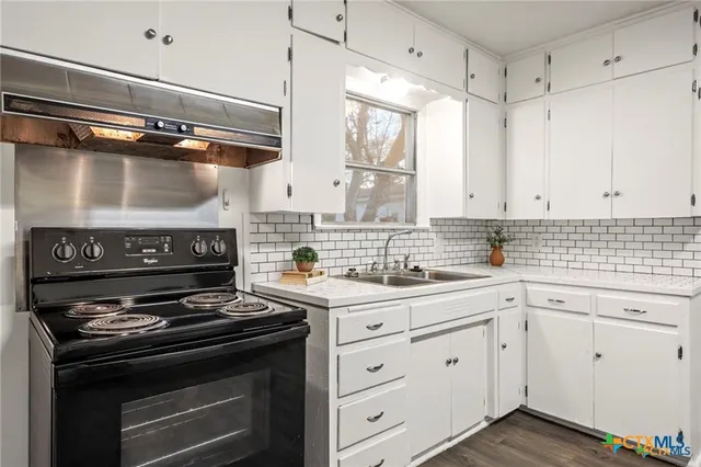 a kitchen with a sink and a window