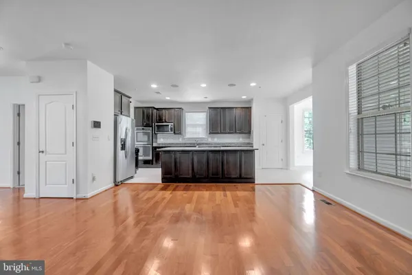 a view of a room with wooden floor and a window