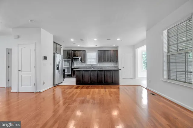 a view of a room with wooden floor and a window