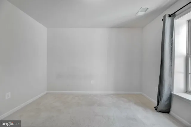 a view of a kitchen with wooden floor and electronic appliances