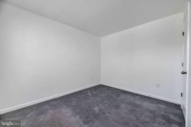 a view of a house with a big yard and large trees