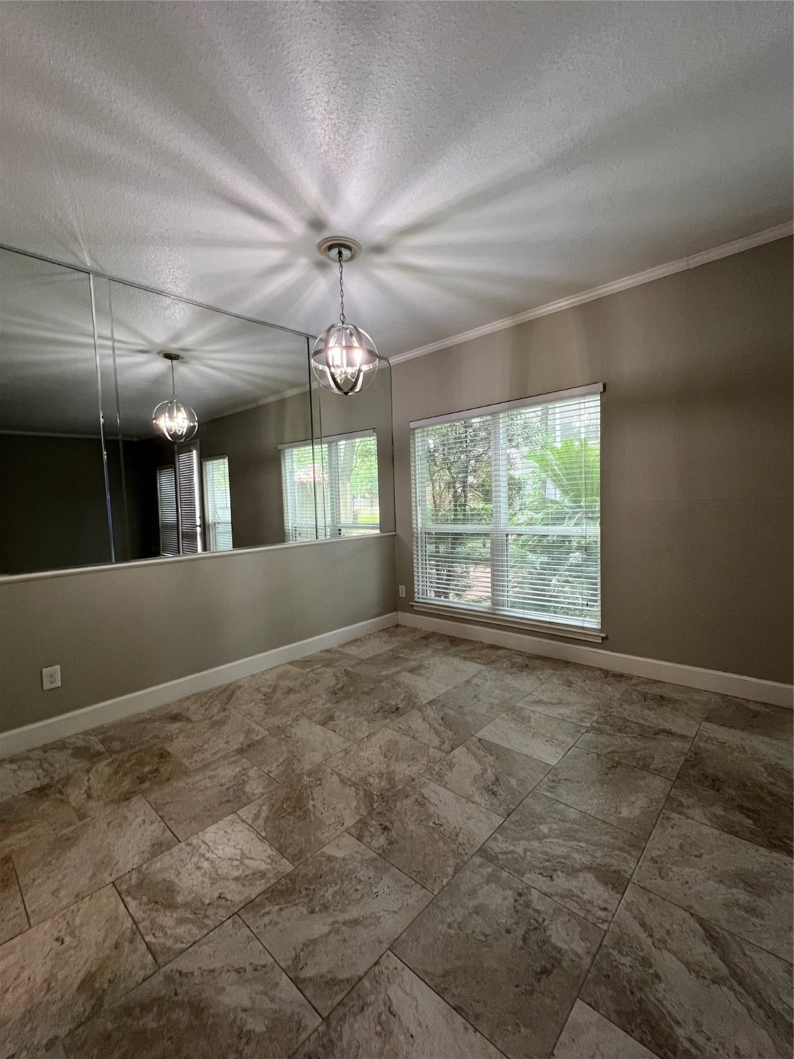 2100 Tanglewilde Street, Unit 455 Houston, TX 77063 - Photo 10 of 37 Back inside, the formal dining space is anchored by a pendant light, and the mirrored wall allows the natural light to bounce through the windows into the home!