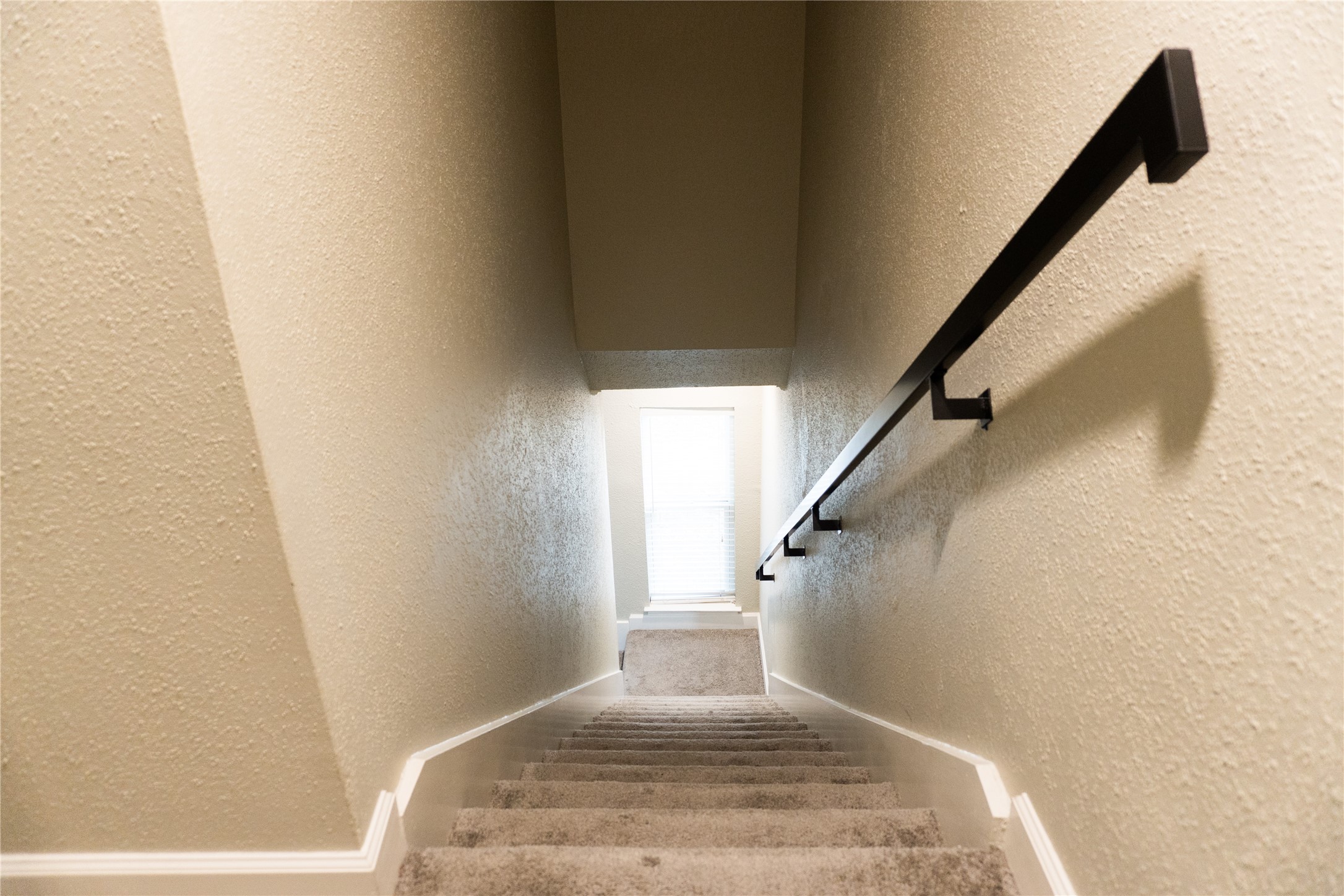 2100 Tanglewilde Street, Unit 455 Houston, TX 77063 - Photo 17 of 37 A carpeted staircase leads you to the upstairs bedroom and ensuite bath!