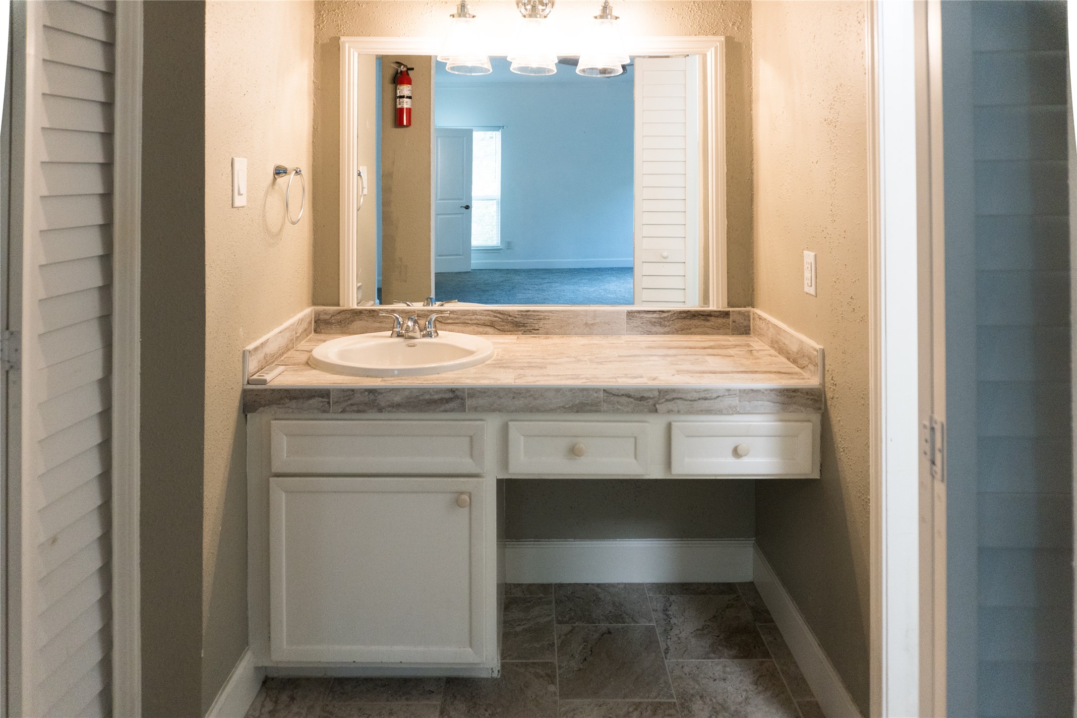 2100 Tanglewilde Street, Unit 455 Houston, TX 77063 - Photo 24 of 37 The crisp white cabinets, flooring that matches the countertops creates a cohesive look in this ensuite space!
