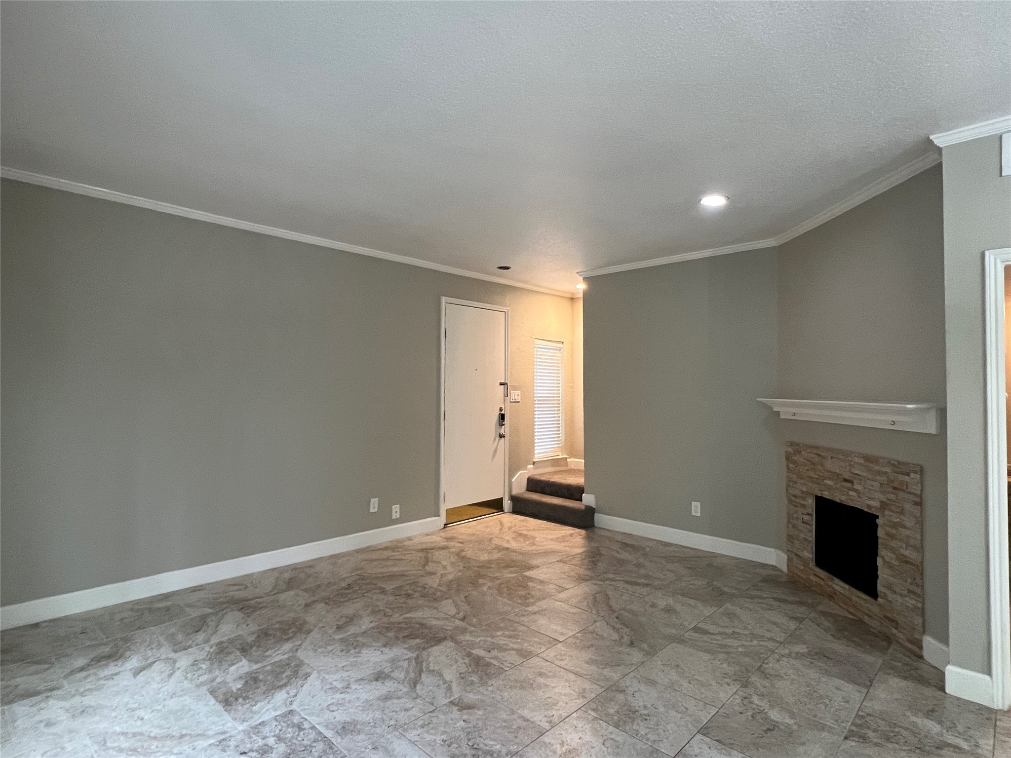 2100 Tanglewilde Street, Unit 455 Houston, TX 77063 - Photo 7 of 37 This unit boasts a corner fireplace place adorned with stacked stone, and a wooden mantel that will surely warm the hearts of all that gather here! And neutral paint tones, tile with crown molding complete the space!