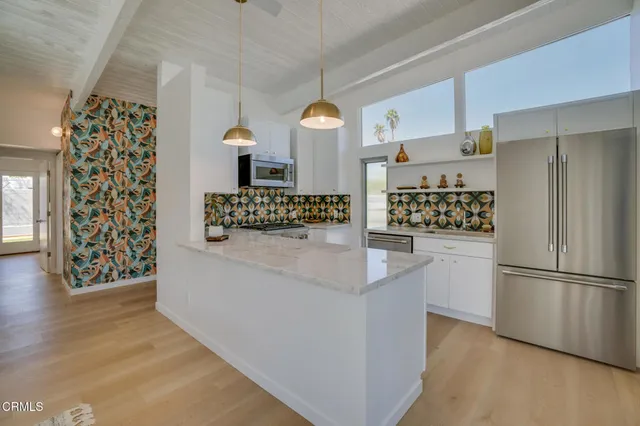 a kitchen with stainless steel appliances a stove sink and cabinets