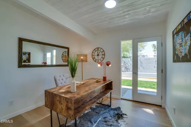 a bed sitting in a bedroom next to a window